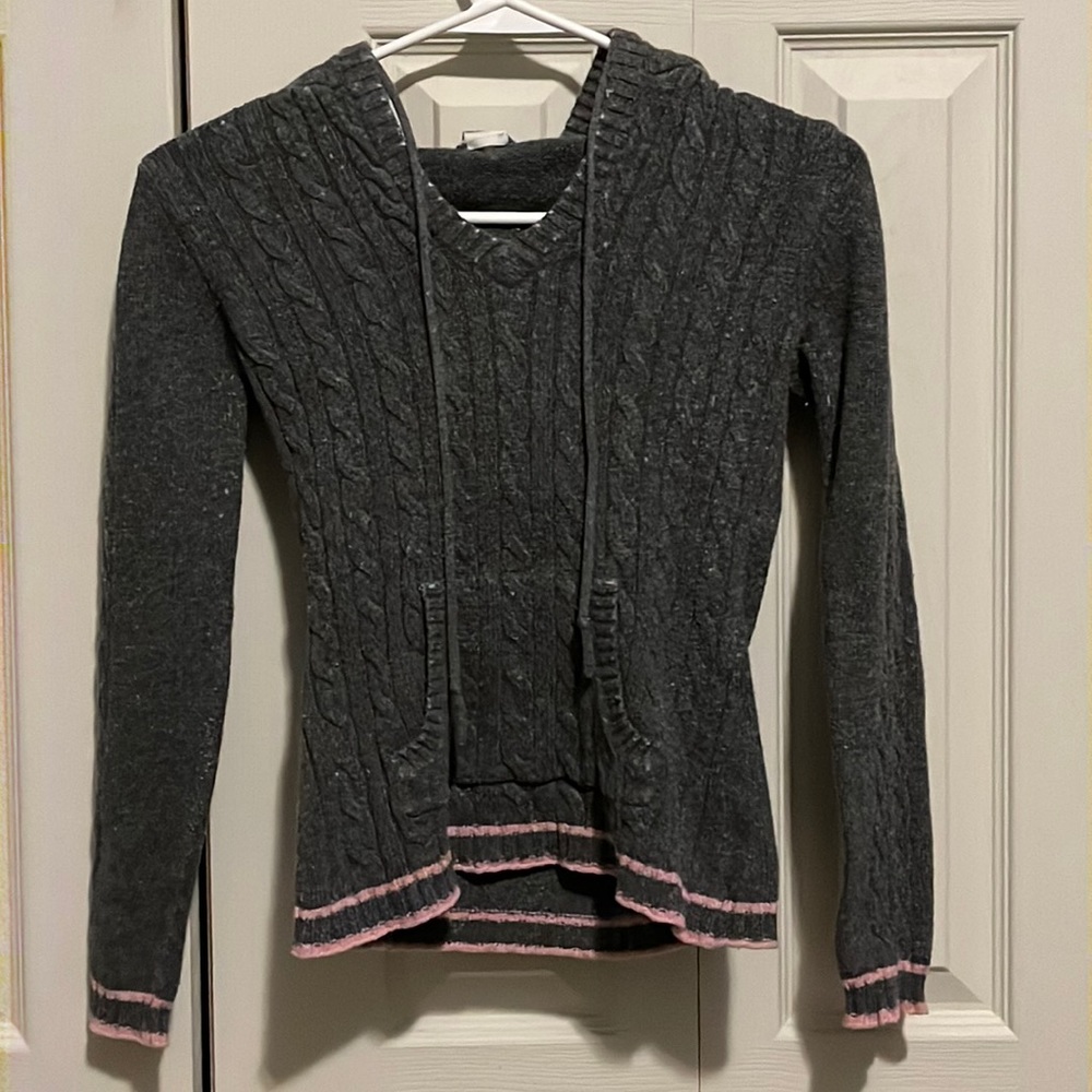 Dark gray sweater with light pink stripes around the bottom
